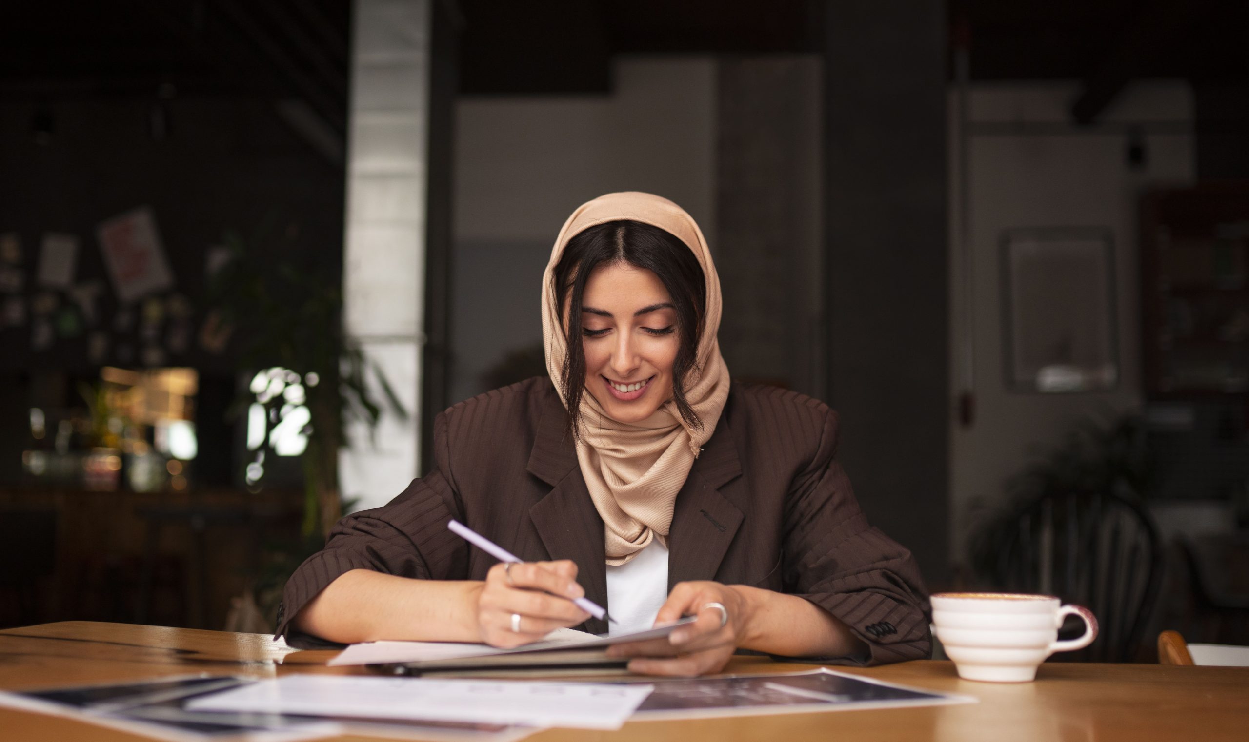 medium-shot-woman-working-with-hijab-indoors-min
